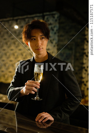 Man drinking at a bar 115187571