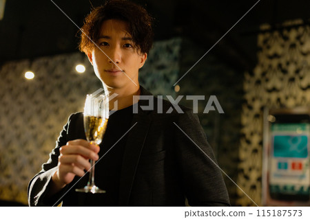 Man drinking at a bar Man drinking at a bar 115187573