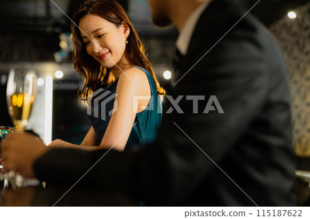 Men and women drinking at a bar Men and women drinking at a bar 115187622