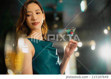 A woman with a cocktail A woman with a cocktail 115187649