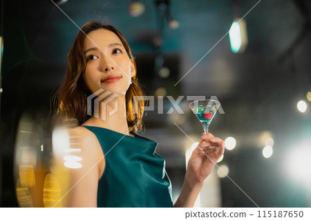 A woman with a cocktail 115187650