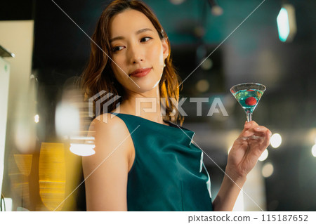 A woman with a cocktail A woman with a cocktail 115187652