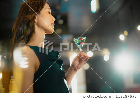 A woman with a cocktail 115187653