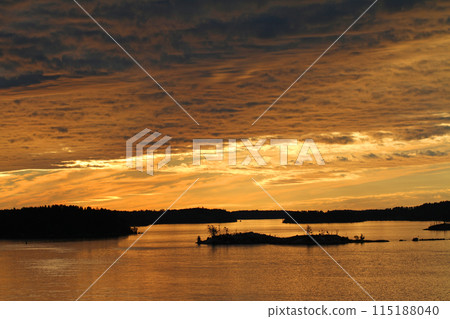 View from a boat across the islands of Lake Mälaren during the midnight sun 115188040