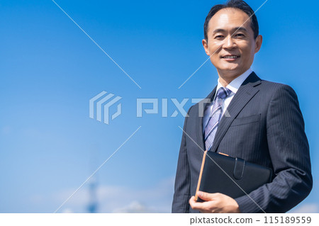 A refreshing middle-aged male businessman with a smile 115189559