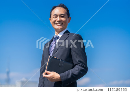 A refreshing middle-aged male businessman with a smile A refreshing middle-aged male businessman with a smile 115189563