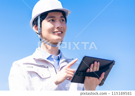 A young male engineer conducting a maintenance inspection 115189581