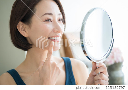 A woman in her 40s with white teeth 115189797
