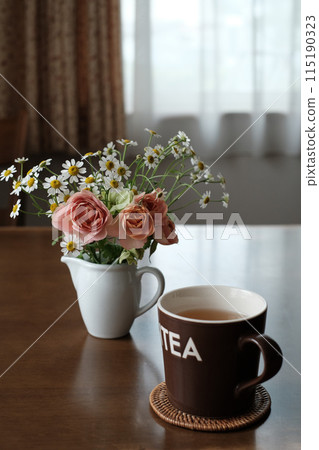 Flowers and mug on the table in the living room 115190323