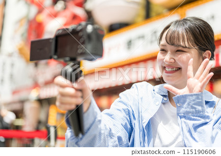 Young and pretty woman taking a selfie in the city's downtown area | Osaka Tourism Image | Dotonbori Shopping Street, Osaka City, Osaka Prefecture Young and pretty woman taking a selfie in the city's downtown area | Osaka Tourism Image | Dotonbori Shopping Street, Osaka City, Osaka Prefecture 115190606