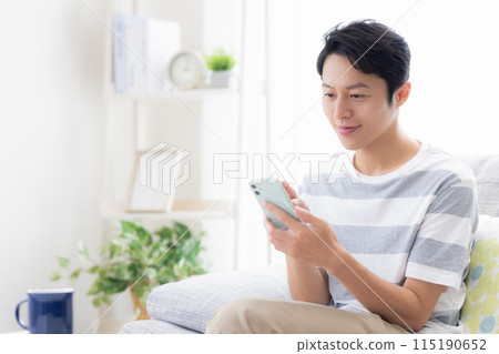 Man looking at a smartphone Man looking at a smartphone 115190652