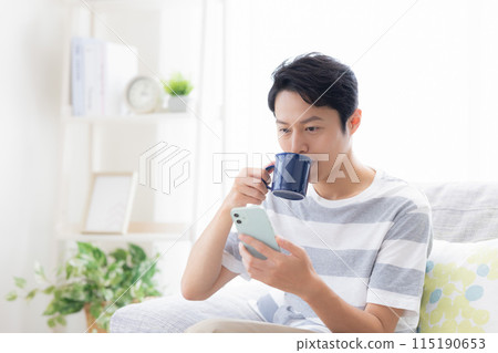 Man looking at a smartphone Man looking at a smartphone 115190653