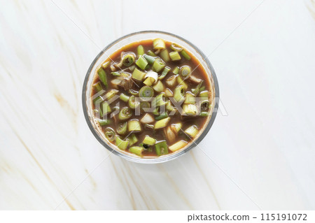 Spring Onion Coffee Or Scallion Coffee, Popular Beverage In China. Top View Glass Of Drink, Cappuccino Or Latte With Onions On Granite Table. Horizontal Plane. 115191072