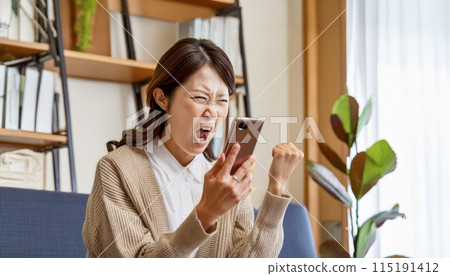 Young Asian woman complaining over the phone 115191412