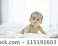Baby lying on bed 115191603