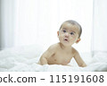 Baby lying on bed 115191608