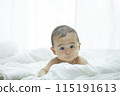 Baby lying on bed 115191613