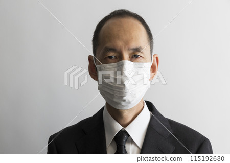 Portrait of a middle-aged Japanese man in a suit wearing a mask Portrait of a middle-aged Japanese man in a suit wearing a mask 115192680