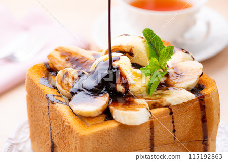 Vanilla ice cream, chocolate, banana and honey toast topped with chocolate sauce Vanilla ice cream, chocolate, banana and honey toast topped with chocolate sauce 115192863