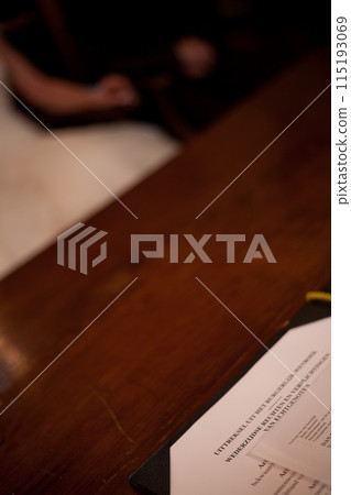 The couple signs marriage certificate during wedding, symbolizing commitment and love The couple signs marriage certificate during wedding, symbolizing commitment and love 115193069