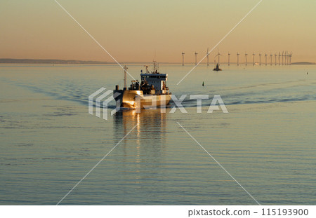 Ships and offshore wind power generation off the coast of Copenhagen during the white nights 115193900