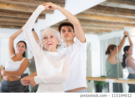 Elderly woman and young boy dancing as couple 115194012