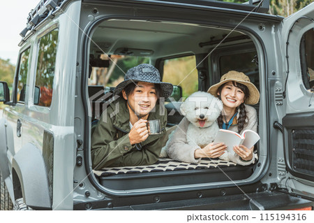 Young Asian couple, husband and wife, campers driving with dog/pet, day camping, camping, sleeping in a car Young Asian couple, husband and wife, campers driving with dog/pet, day camping, camping, sleeping in a car 115194316