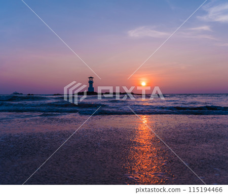 A lighthouse in the ocean during a beautiful sunset 115194466