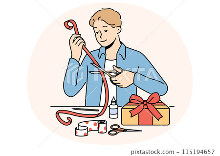 Man makes gift with own hands decorating box with red ribbon with festive paper. 115194657