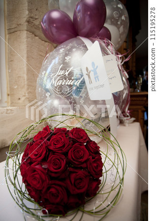 Decorate with red rose bouquet and Just Married balloons for a beautiful wedding celebration 115195278
