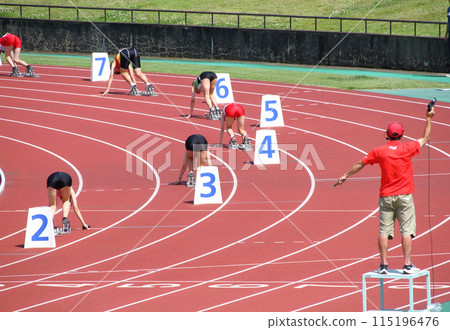 Start of the women's 400m relay at the track and field meet Start of the women's 400m relay at the track and field meet 115196476