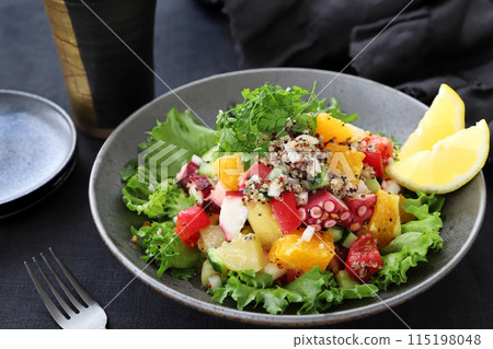 Refreshing summer ceviche with octopus, fruit and quinoa marinated salad 115198048