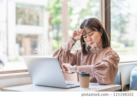 Young Asian business woman worried about being busy with work in cafe coworking space Young Asian business woman worried about being busy with work in cafe coworking space 115198101