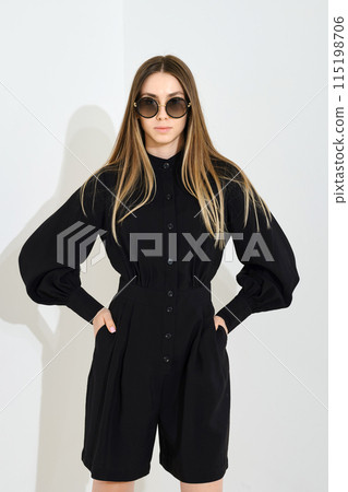 Young woman posing in shorts and blouse Young woman posing in shorts and blouse 115198706