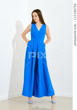 Pretty woman in blue long sleeveless dress Pretty woman in blue long sleeveless dress 115198756