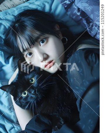 Portrait of a Japanese woman holding a black cat 115201249