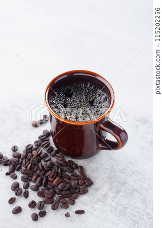 A cup of freshly brewed aromatic coffee and coffee beans 115202256