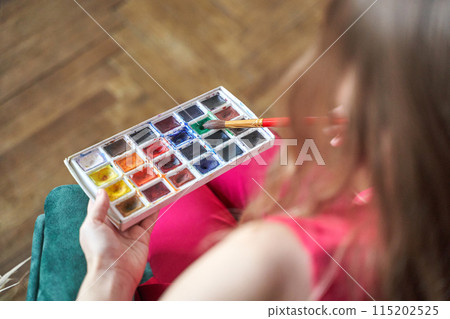 Woman holding brush at hand. Watercolor color palette. Art drawing process 115202525