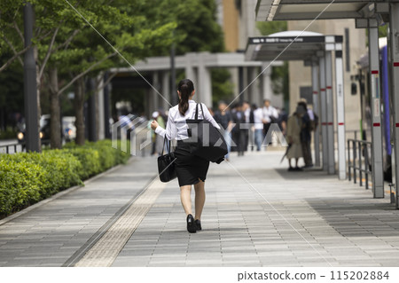 Young woman walking through Tokyo's business district Young woman walking through Tokyo's business district 115202884