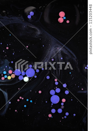 A myriad of oil droplets intermingling with water, creating a mesmerizing effect reminiscent of a galaxy. A myriad of oil droplets intermingling with water, creating a mesmerizing effect reminiscent of a galaxy. 115203448