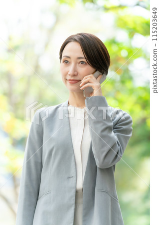 Business woman, smartphone, green, vertical Business woman, smartphone, green, vertical 115203649