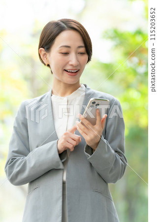 Business woman, smartphone, green, vertical 115203652