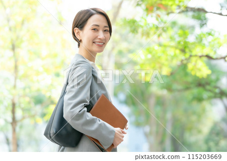 Business woman turning around green 115203669