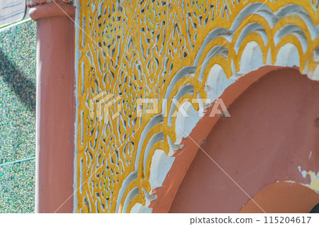Elements of designer decoration of exterior parts of houses on streets of the city of Tangier in the Kingdom of Morocco. folk arts in the elements of decoration of facades of buildings, houses 115204617