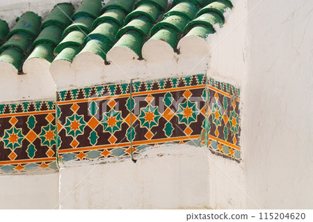 Elements of designer decoration of exterior parts of houses on streets of the city of Tangier in the Kingdom of Morocco. folk arts in the elements of decoration of facades of buildings, houses 115204620