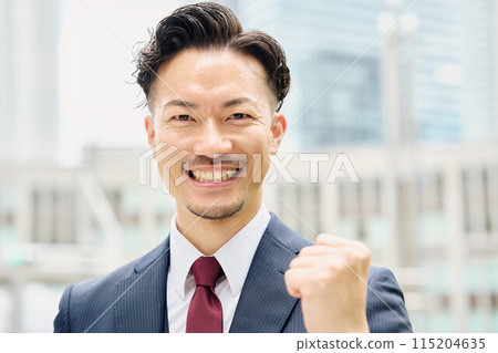 Businessman who plays guts pose Businessman who plays guts pose 115204635