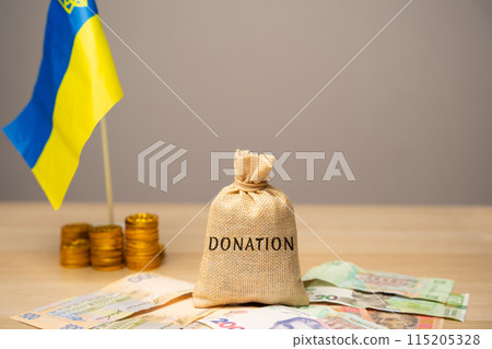Money bag Donation, Ukrainian flag and hryvnia bills. The concept of monetary assistance to the Ukrainian economy due to the war. Financial help to Ukraine. 115205328
