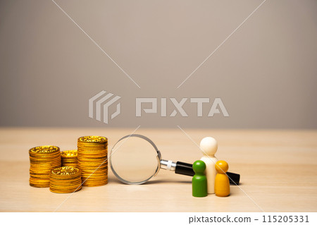 Family figures near a magnifying glass and coins. Search for money, poor financial situation in the family and poverty. Look for a sponsor. Begging and donation 115205331