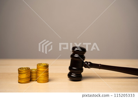Judge's gavel and stack of coins. Litigation, dispute resolution, conflict of interest settlement. Awarding moral financial compensation. Justice, rule of law. Lawyer services. Protection of rights 115205333