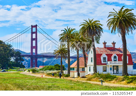 Buildings and palm trees along path with people walking toward Golden Gate Bridge Buildings and palm trees along path with people walking toward Golden Gate Bridge 115205347